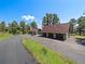 Exterior of property, with home, oversized garage and mature trees at 3800 Lakota Rd, Indian Hills, CO 80454