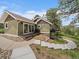 Exterior of a cozy home with a deck and walkout basement, featuring a stone foundation and inviting outdoor spaces at 3800 Lakota Rd, Indian Hills, CO 80454