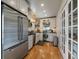 This bright kitchen has stainless appliances, wood-look accents, and access to another room at 3800 Lakota Rd, Indian Hills, CO 80454