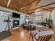 Inviting living room with a fireplace, wood flooring, and stylish decor at 3800 Lakota Rd, Indian Hills, CO 80454