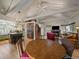 Inviting living room with exposed beam ceilings, a fireplace, hardwood floors, and an open-concept design at 3800 Lakota Rd, Indian Hills, CO 80454