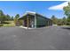 Spacious outbuilding with multiple garage doors and a covered area, ideal for storage or workshop space on the property at 3800 Lakota Rd, Indian Hills, CO 80454