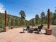 Stunning patio with outdoor seating and a beautiful hillside view, perfect for relaxing and entertaining at 3800 Lakota Rd, Indian Hills, CO 80454