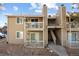 Tan two-story building with stairs and balconies at 1960 S Xanadu Way # 208, Aurora, CO 80014