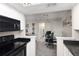 Modern kitchen with black appliances and white cabinetry at 1960 S Xanadu Way # 208, Aurora, CO 80014