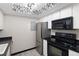 Modern kitchen with stainless steel appliances and dark countertops at 1960 S Xanadu Way # 208, Aurora, CO 80014