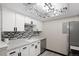 Charming kitchen with stainless steel appliances, white cabinets, mosaic backsplash, and modern track lighting at 1960 S Xanadu Way # 208, Aurora, CO 80014