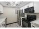 Bright kitchen with stainless steel appliances, white cabinetry, gray counters, and modern lighting at 1960 S Xanadu Way # 208, Aurora, CO 80014