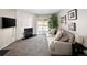 Inviting living room features a cozy fireplace, sliding door to the patio, and comfortable seating at 1960 S Xanadu Way # 208, Aurora, CO 80014