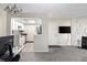 Open-concept living room featuring a view into the kitchen and access to the front door, offering a welcoming atmosphere at 1960 S Xanadu Way # 208, Aurora, CO 80014
