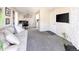 Bright living room featuring neutral tones, plush carpeting, and ample natural light, creating a welcoming space at 1960 S Xanadu Way # 208, Aurora, CO 80014