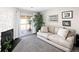 Comfortable living room featuring a fireplace, plush couch, and a sliding door to the patio at 1960 S Xanadu Way # 208, Aurora, CO 80014