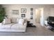 Bright and airy living room with a cozy sofa, natural light, and a comfortable space for relaxation and entertainment at 1960 S Xanadu Way # 208, Aurora, CO 80014