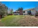 Spacious backyard with a brick chimney, covered patio, and lush green lawn at 4570 S Kalispell Way, Aurora, CO 80015