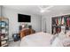 Grey primary bedroom with desk, ceiling fan, and closet at 4570 S Kalispell Way, Aurora, CO 80015