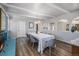 Open dining room with wood floors, modern chandelier, and space for large gatherings at 4570 S Kalispell Way, Aurora, CO 80015