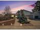 Charming home with a well-maintained front yard and an attached two-car garage at dusk at 4570 S Kalispell Way, Aurora, CO 80015