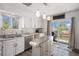 Bright kitchen with white cabinets, stainless steel appliances, and sliding door to the backyard at 4570 S Kalispell Way, Aurora, CO 80015