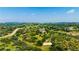 Expansive aerial view of the home nestled in a lush, green landscape with rolling hills at 4320 Stone Post Dr, Castle Rock, CO 80108