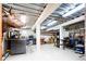 Unfinished basement with work tables, shelving, and fluorescent lighting at 4320 Stone Post Dr, Castle Rock, CO 80108