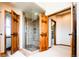 Bathroom featuring a glass-enclosed shower with tiled walls and flooring at 4320 Stone Post Dr, Castle Rock, CO 80108
