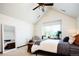 Bright bedroom featuring vaulted ceiling, a ceiling fan, and a large window with tree views at 4320 Stone Post Dr, Castle Rock, CO 80108
