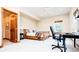Bedroom featuring a light wood bedframe, an adjacent office space, and carpeted floors at 4320 Stone Post Dr, Castle Rock, CO 80108