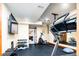 Basement gym area with rubber flooring, exercise equipment, and a wall mounted TV at 4320 Stone Post Dr, Castle Rock, CO 80108