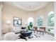 Sitting area featuring arched windows, contemporary decor, and a comfortable seating area at 4320 Stone Post Dr, Castle Rock, CO 80108