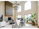 Bright living room features a fireplace, two-story ceilings, and updated modern lighting at 4320 Stone Post Dr, Castle Rock, CO 80108
