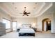 Spacious main bedroom with tray ceilings, neutral decor, and access to the en suite bathroom at 4320 Stone Post Dr, Castle Rock, CO 80108