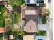 Aerial view of backyard showing a patio, lush grass, wooden fencing, and a garden at 4917 S Xenophon Way, Morrison, CO 80465