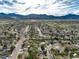 Expansive aerial view of a residential neighborhood nestled among rolling hills and mature trees at 4917 S Xenophon Way, Morrison, CO 80465