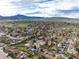 Wide aerial view of a neighborhood nestled amongst mountain range in the background at 4917 S Xenophon Way, Morrison, CO 80465