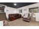 Cozy basement living area with carpet, comfortable seating and natural light from windows at 4917 S Xenophon Way, Morrison, CO 80465