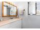 Bathroom featuring a vanity with a sink and mirror, and a window at 4917 S Xenophon Way, Morrison, CO 80465