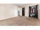 Bedroom with carpet flooring, closet storage, and views through a window at 4917 S Xenophon Way, Morrison, CO 80465