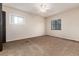 Spacious carpeted bedroom with natural light from two windows at 4917 S Xenophon Way, Morrison, CO 80465