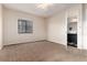 Neutral bedroom with carpet flooring, a window, and a connected bathroom at 4917 S Xenophon Way, Morrison, CO 80465