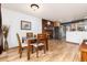 Inviting dining area features a brick fireplace and wood floors, creating a cozy atmosphere at 4917 S Xenophon Way, Morrison, CO 80465