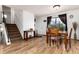 Bright dining room with hardwood floors and large window offering natural light at 4917 S Xenophon Way, Morrison, CO 80465