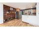 A brick fireplace highlights this dining area with wood floors and stainless steel refrigerator at 4917 S Xenophon Way, Morrison, CO 80465