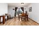 Dining room with hardwood floors, natural light, and view of the front yard at 4917 S Xenophon Way, Morrison, CO 80465