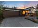 Charming brick home featuring an attached garage and well-kept front yard at sunset at 4917 S Xenophon Way, Morrison, CO 80465