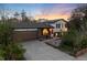 Charming split-level home showcasing a well-maintained lawn, mature trees, and warm sunset colors at 4917 S Xenophon Way, Morrison, CO 80465