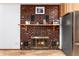 Living room with a cozy brick fireplace and stylish decor at 4917 S Xenophon Way, Morrison, CO 80465