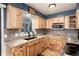 Well-lit kitchen features wood cabinets, granite countertops and stainless steel microwave at 4917 S Xenophon Way, Morrison, CO 80465