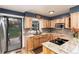 Stylish kitchen featuring wood cabinets, granite countertops and sliding glass doors at 4917 S Xenophon Way, Morrison, CO 80465