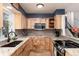 Bright kitchen featuring wood cabinets, granite counters and stainless steel microwave at 4917 S Xenophon Way, Morrison, CO 80465
