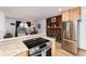 Charming kitchen seamlessly transitions to the dining area with a cozy brick fireplace at 4917 S Xenophon Way, Morrison, CO 80465